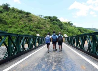 Children crossing bridge to school