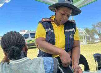 A learner from Lulama Higher Primary School in Soweto is screened by an Integrated School Health nurse.