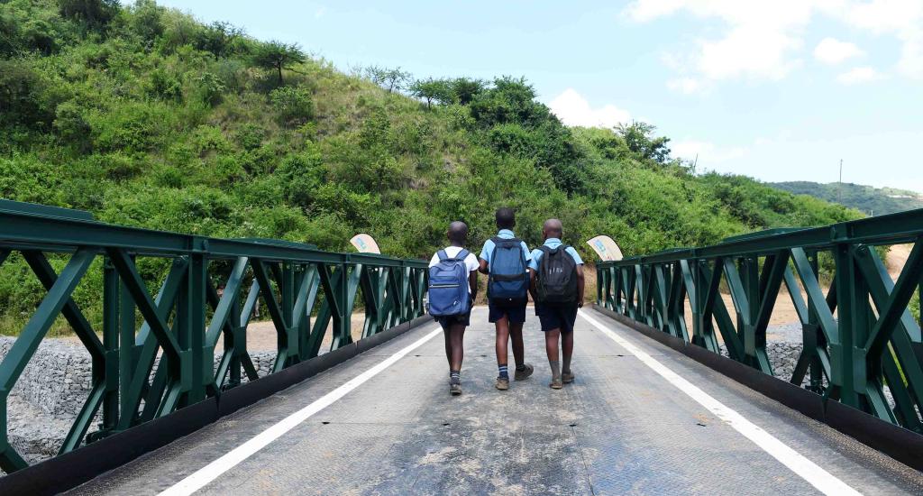 Children crossing bridge to school