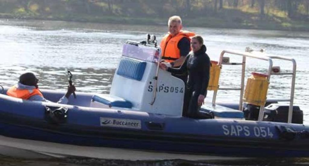  Delport and members of the SAPS diving unit on site during a mission